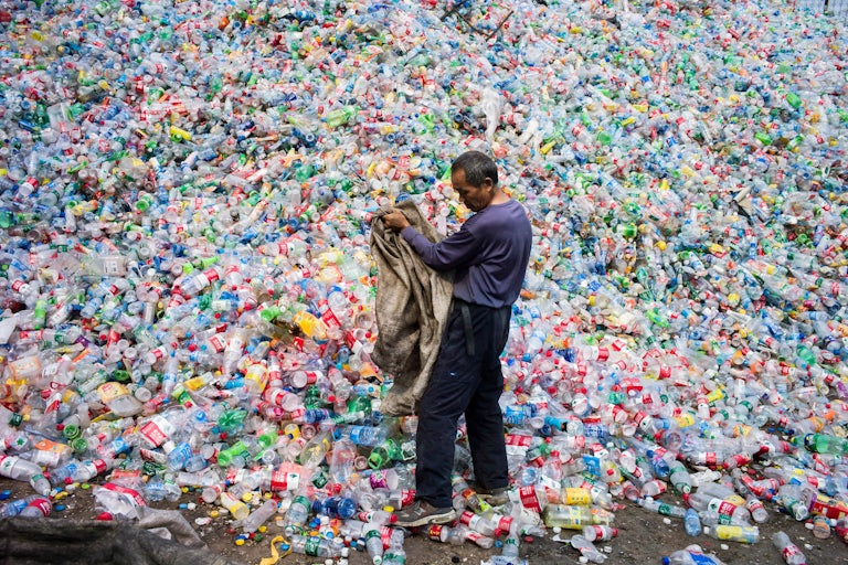 A Chinese laborer sorts plastic bottles