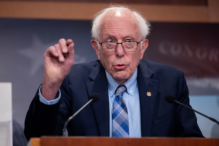 Bernie Sanders gestures while speaking to reporters
