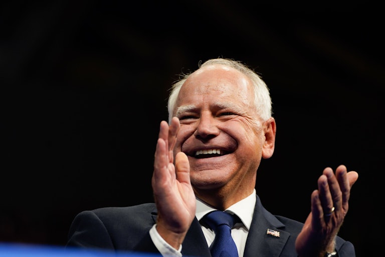 Minnesota Governor Tim Walz laughs and claps