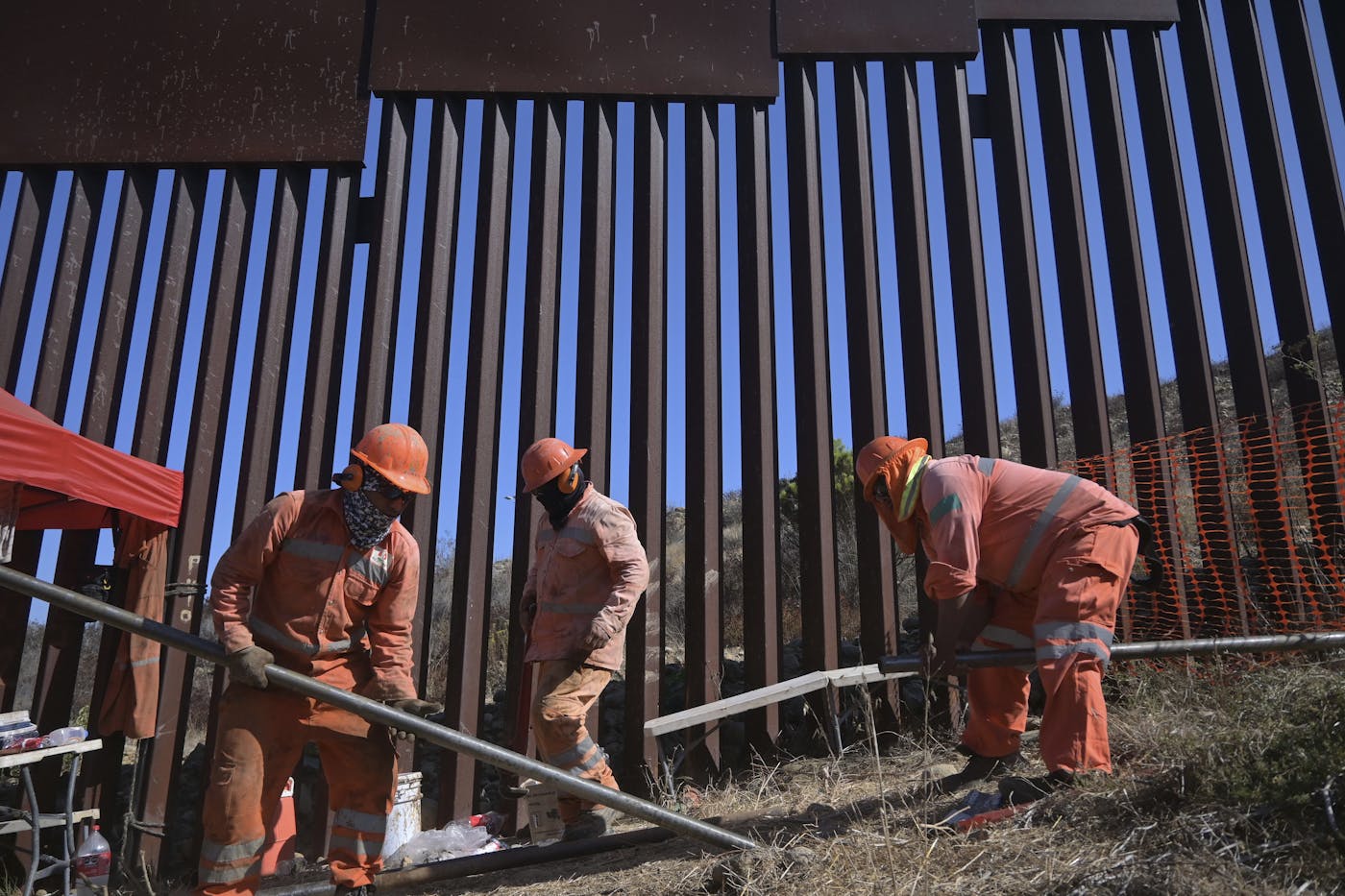 A photograph of Mexican workers repairing broken pipelines connected to the San Antonio de los Buenos sewage treatment plant in Tijuana. Before the plant went offline, it limped along well past its useful life, hobbled by a lack of maintenance.