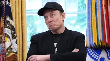 Elon Musk purses his lips and makes a dumb face while crossing his arms in the Oval Office