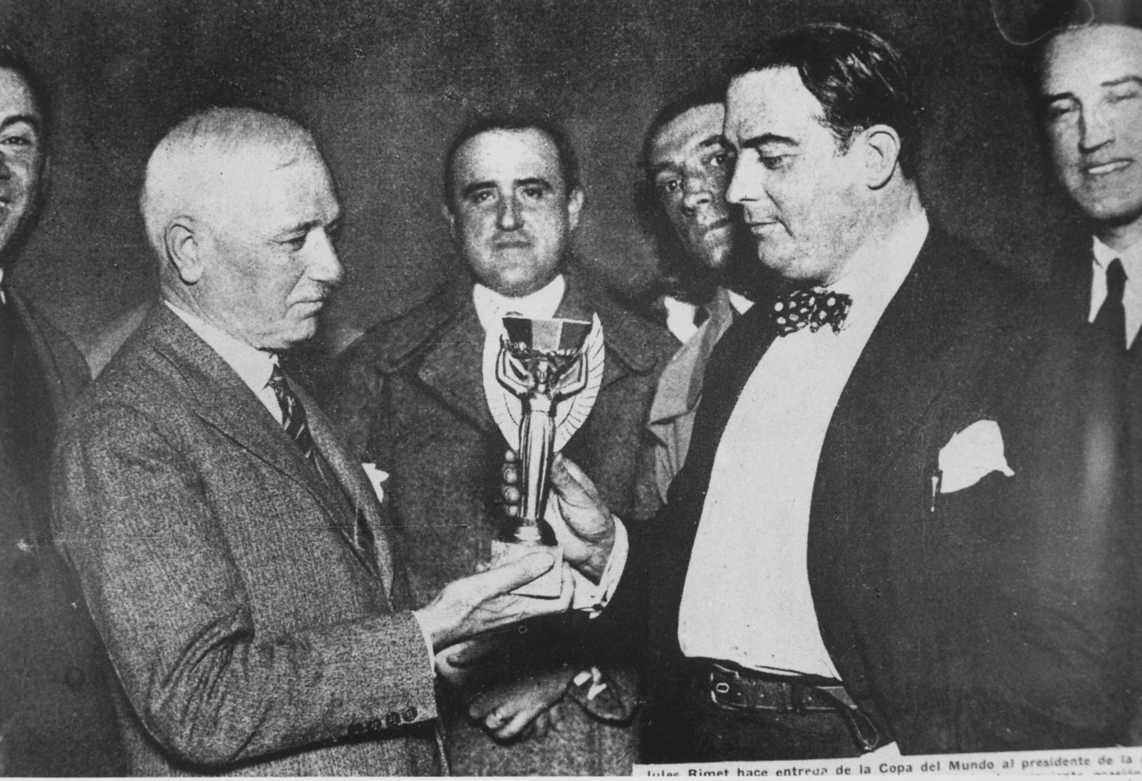 black and white image of the first world cup trophy ceremony featuring fifa president jules rimet and raúl jude, president of the uruguayan soccer association