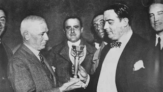 black and white image of the first world cup trophy ceremony featuring fifa president jules rimet and raúl jude, president of the uruguayan soccer association
