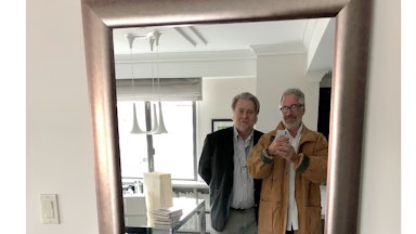Jeffrey Epstein smiles and holds up a phone to take a photo of him and Steve Bannon as they look into a mirror.
