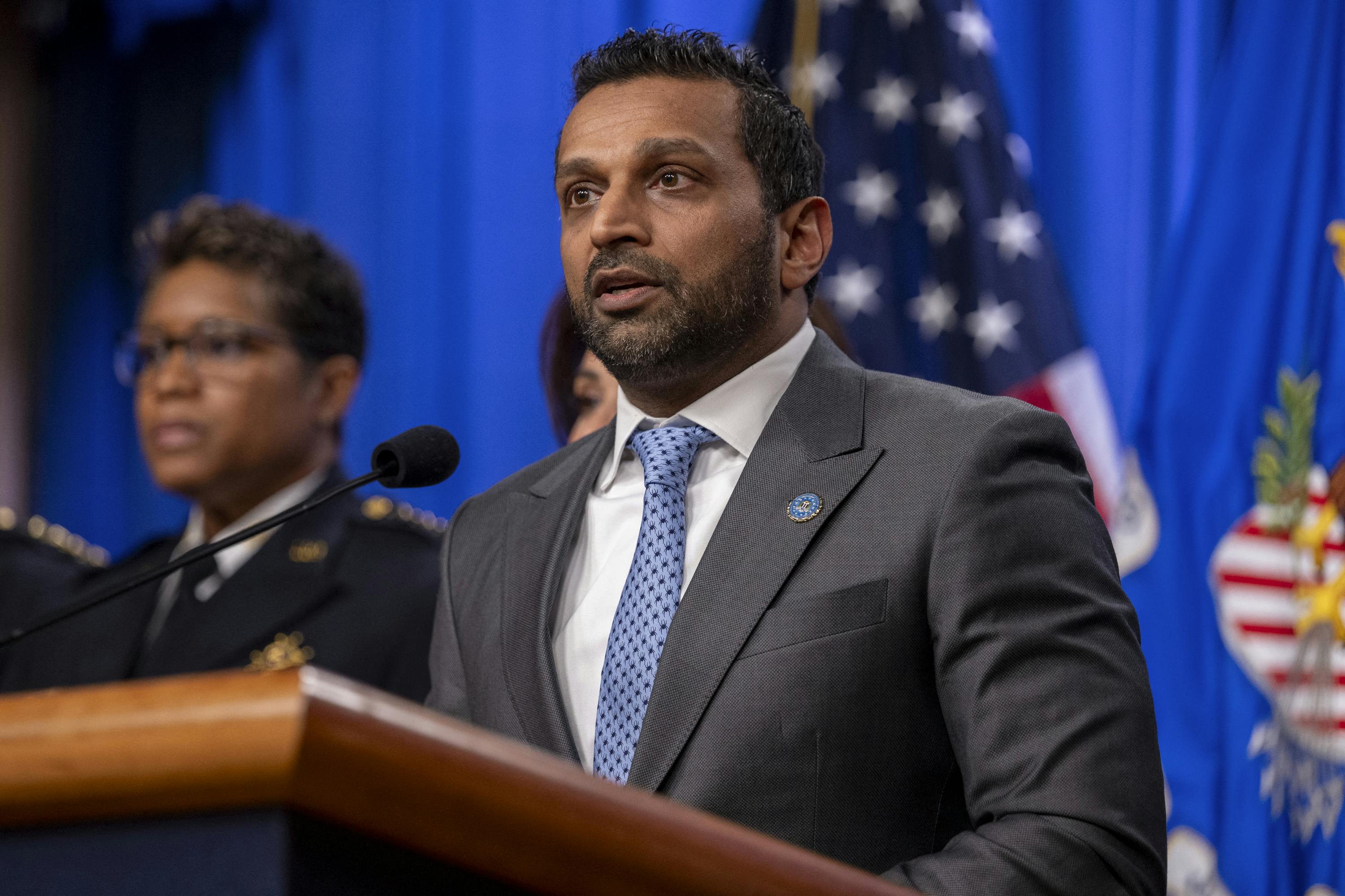 FBI Director Kash Patel speaks at a podium