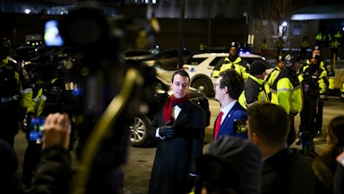 Paul Ingrassia puts his hand on his chest while speaking to reporters