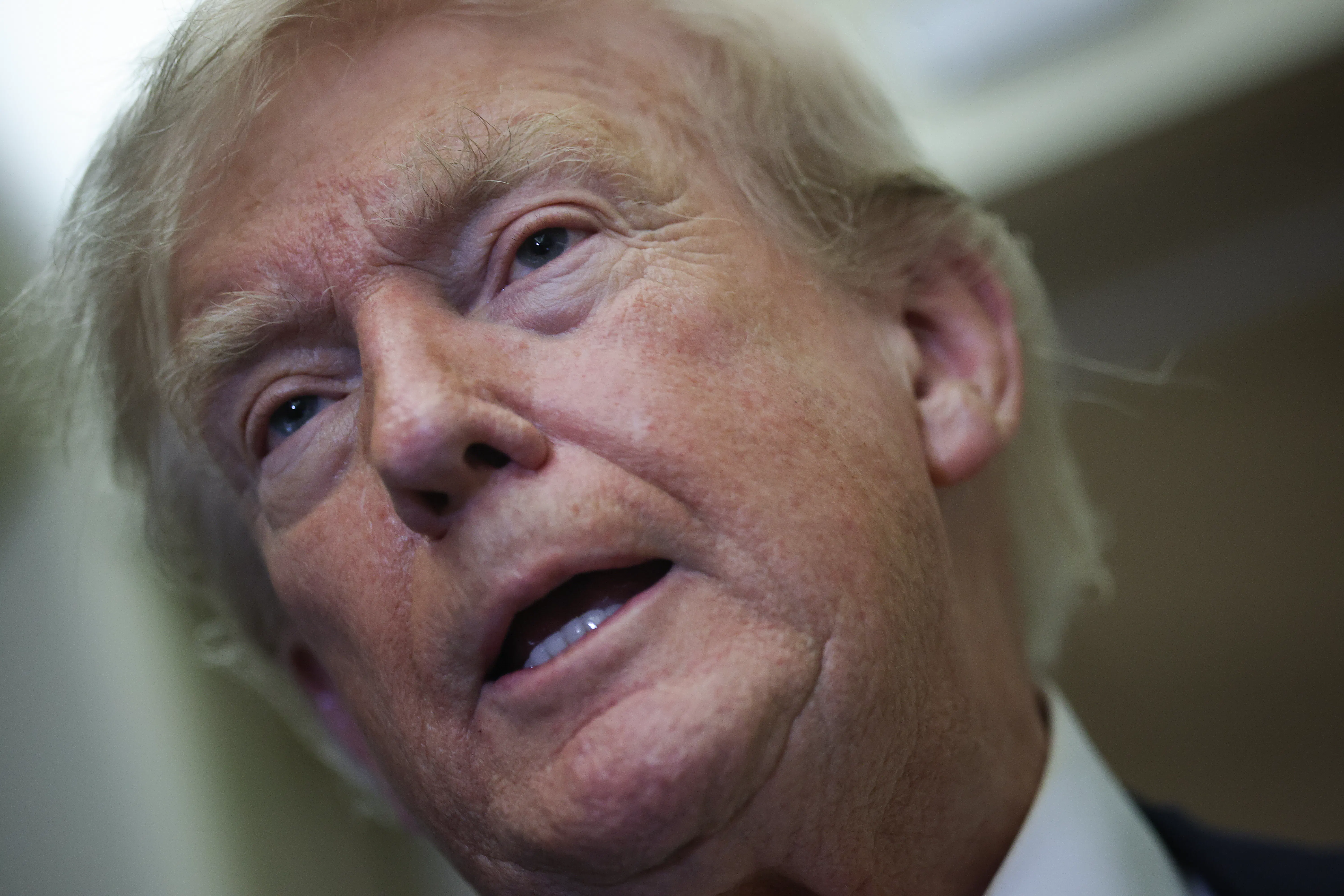 Donald Trump speaks to reporters on Air Force One