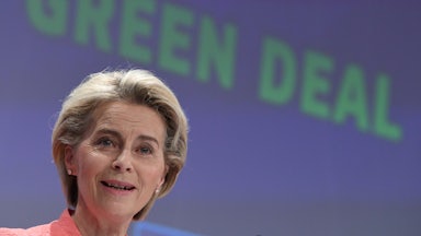 Ursula von der Leyen speaks in front of a screen reading "Green Deal."