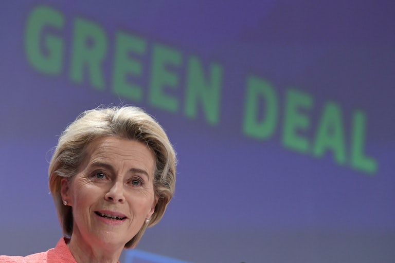 Ursula von der Leyen speaks in front of a screen reading "Green Deal."