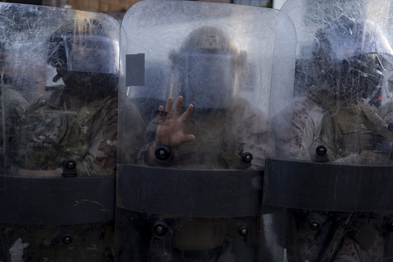 National Guard troops in Los Angeles stand behind their shields