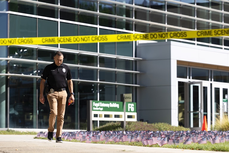 A law enforcement officer walks behind crime scene tape at Utah Valley University, where Charlie Kirk was shot dead