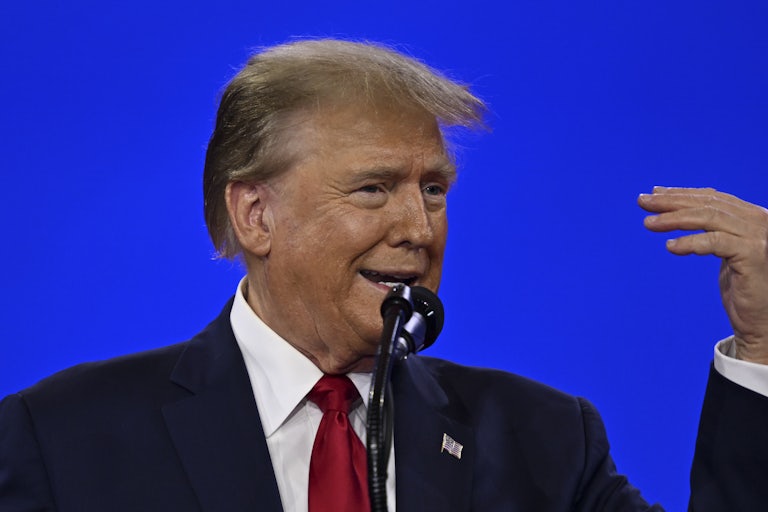 Donald Trump makes a weird face while talking before a mic