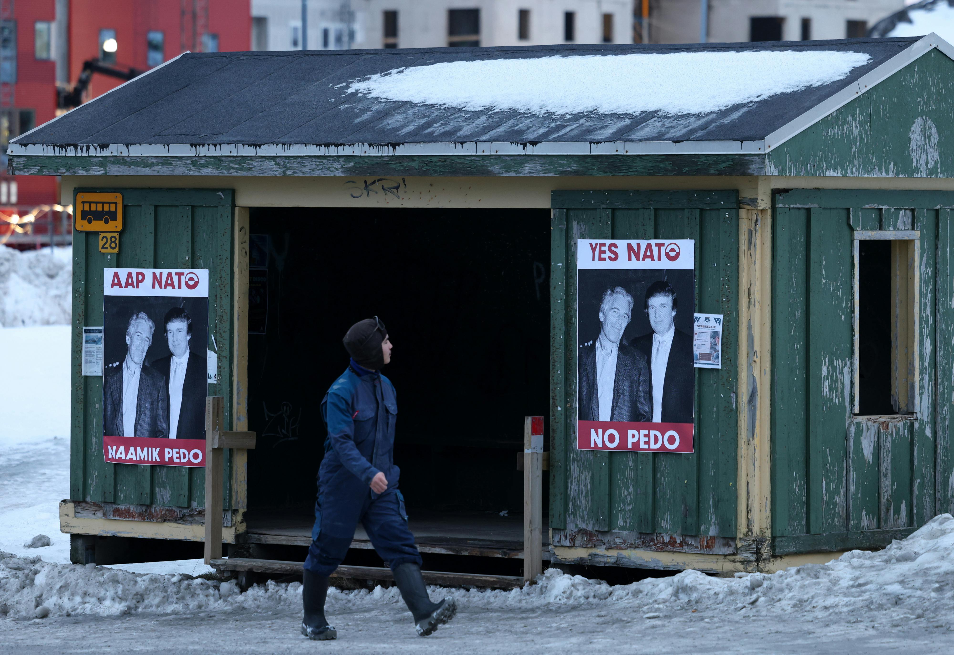 Photos of Donald Trump and Jeffrey Epstein that say, "Yes NATO, no pedo" in English and Greenlandic are posted on a bus stop in Nuuk, Greenland
