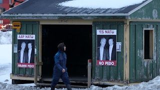 Photos of Donald Trump and Jeffrey Epstein that say, "Yes NATO, no pedo" in English and Greenlandic are posted on a bus stop in Nuuk, Greenland