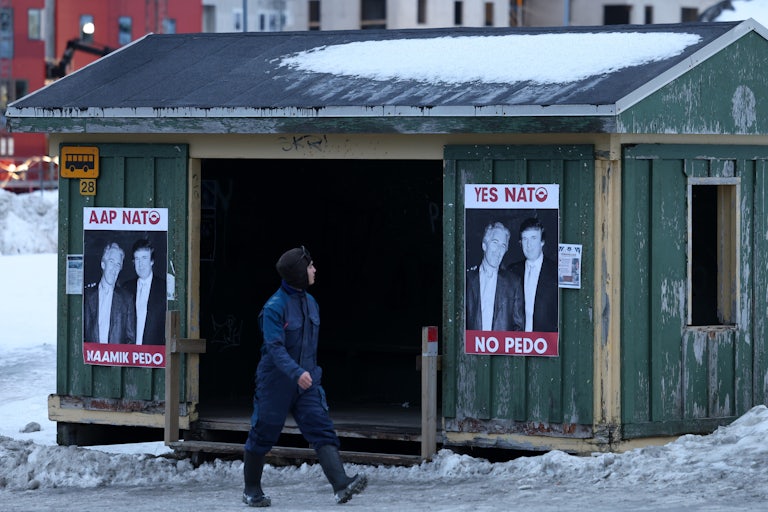 Photos of Donald Trump and Jeffrey Epstein that say, "Yes NATO, no pedo" in English and Greenlandic are posted on a bus stop in Nuuk, Greenland