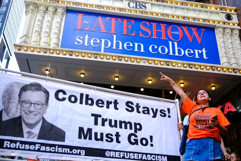 People protest in support of Stephen Colbert outside the Ed Sullivan Theater in New York City