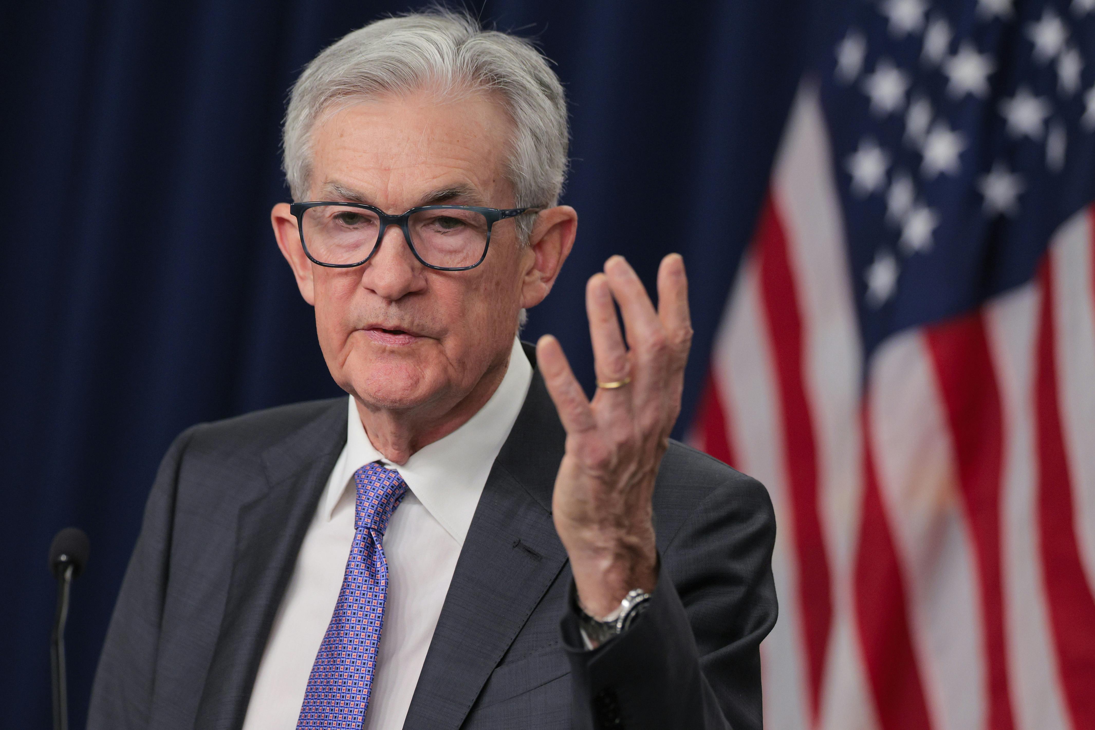 Federal Reserve Chair Jerome Powell speaks as he raises a hand for emphasis