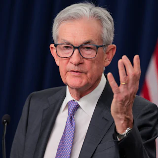 Federal Reserve Chair Jerome Powell speaks as he raises a hand for emphasis