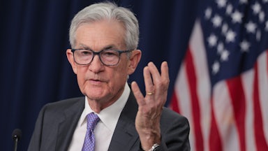 Federal Reserve Chair Jerome Powell speaks as he raises a hand for emphasis