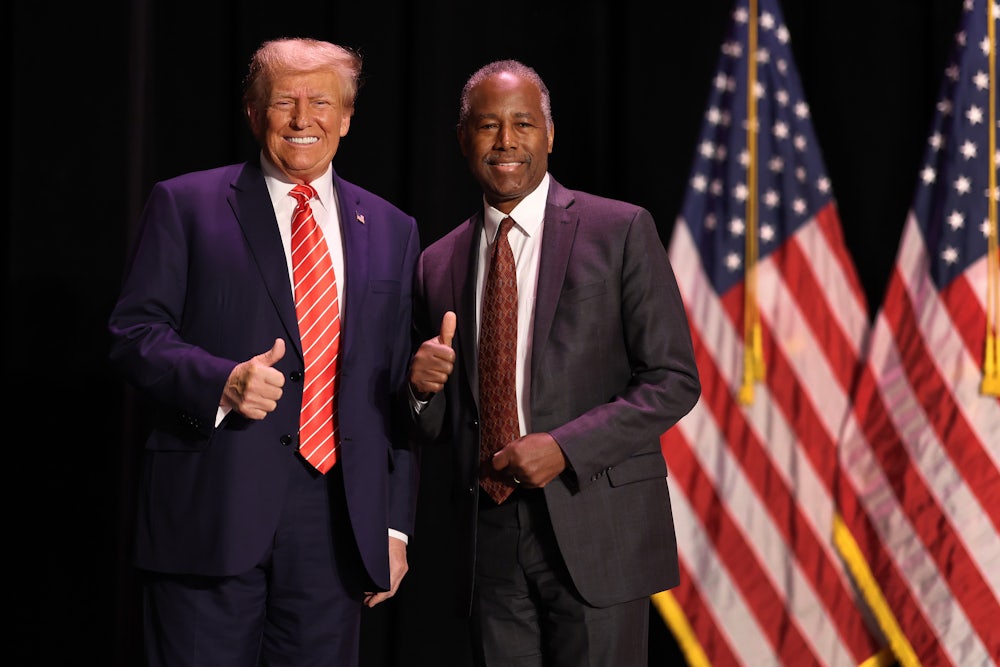 Former President Donald Trump greets his former HUD Secretary, Ben Carson, during a campaign event in Sioux City, Iowa.