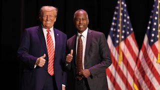 Former President Donald Trump greets his former HUD Secretary, Ben Carson, during a campaign event in Sioux City, Iowa.