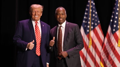 Former President Donald Trump greets his former HUD Secretary, Ben Carson, during a campaign event in Sioux City, Iowa.