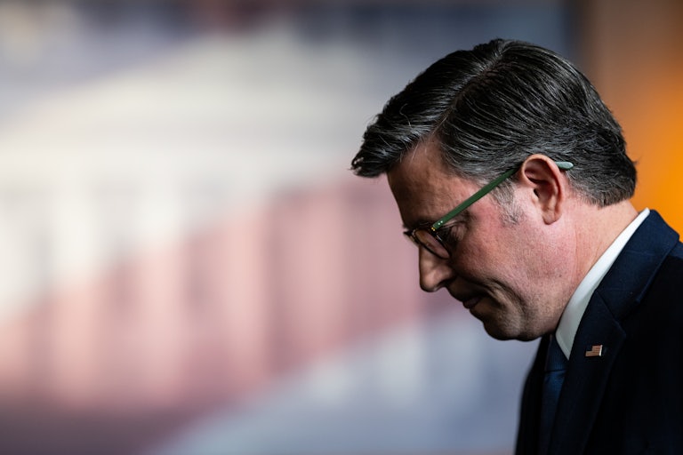 House Speaker Mike Johnson is seen in profile as he looks down