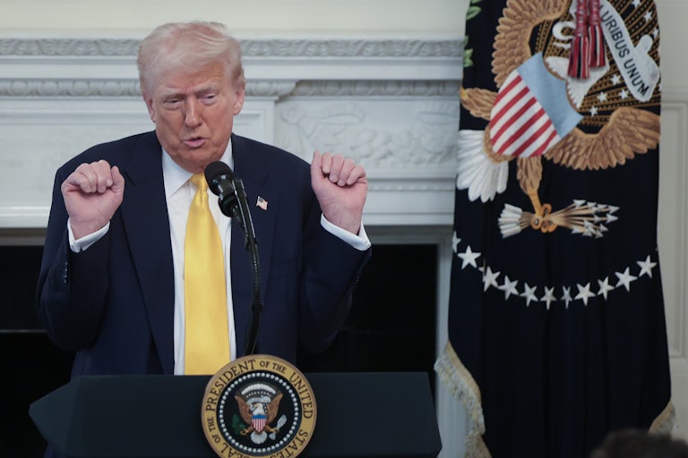 Donald Trump holds up his fists while speaking during a press conference at the White House