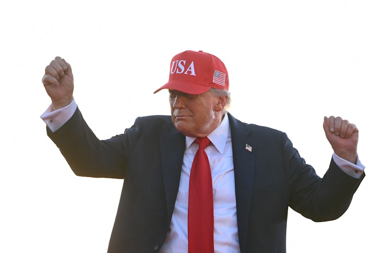Donald Trump dances while wearing a red USA hat