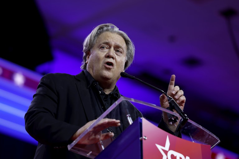 Steve Bannon gestures as he speaks into a microphone