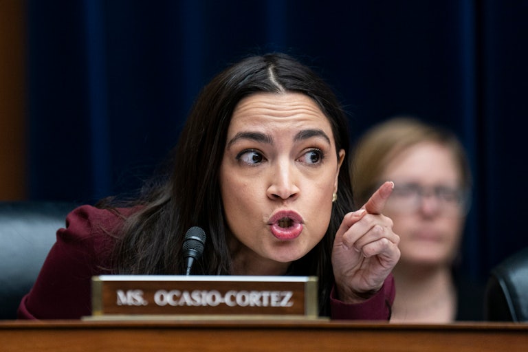 Alexandria Ocasio-Cortez points as she addresses witnesses and her Republican colleagues.