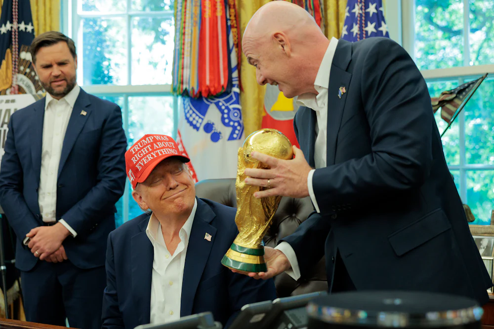 FIFA boss Gianni Infantino shows Donald Trump the World Cup trophy.