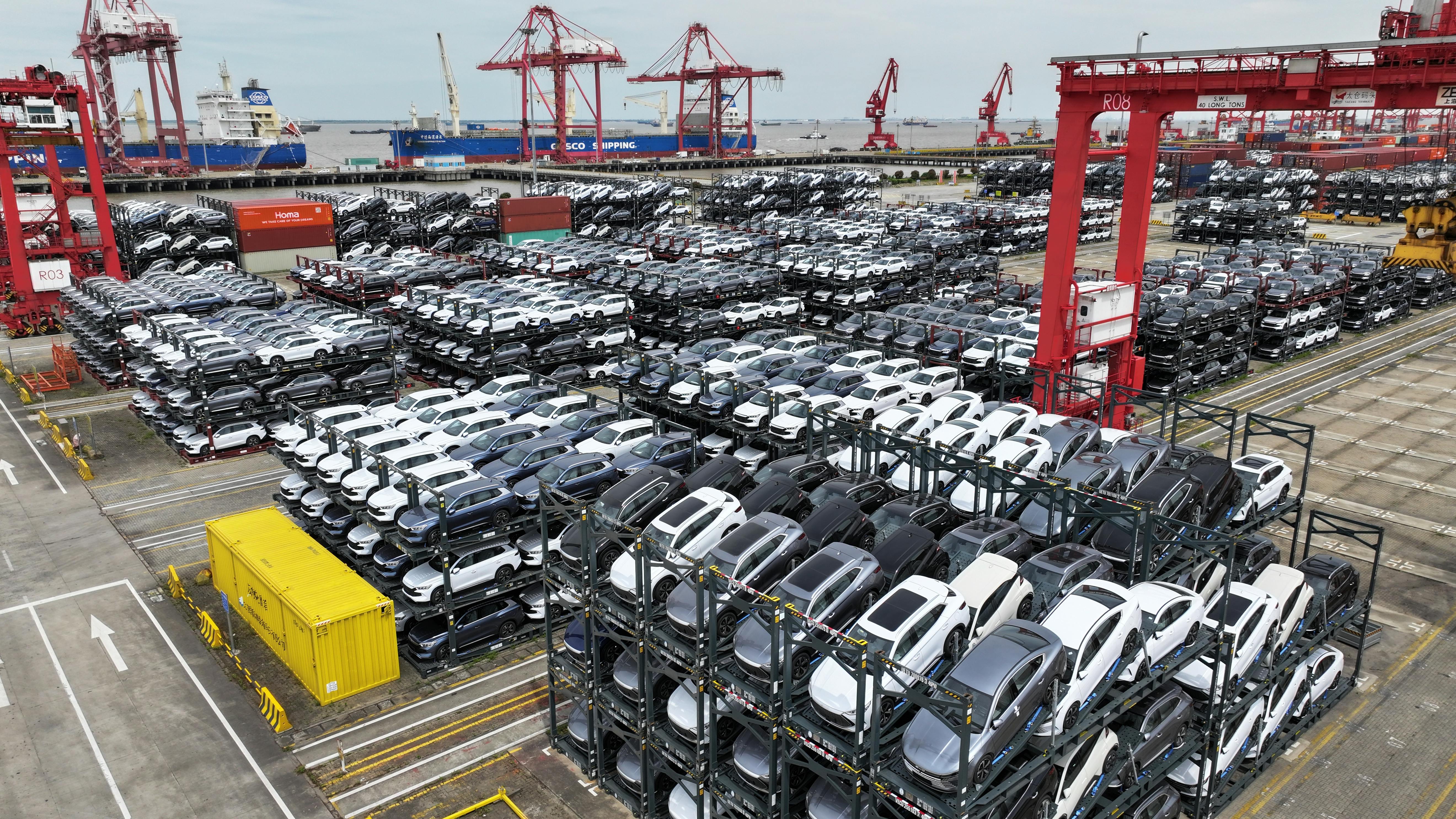 Cars are seen stacked in racks at a container terminal.