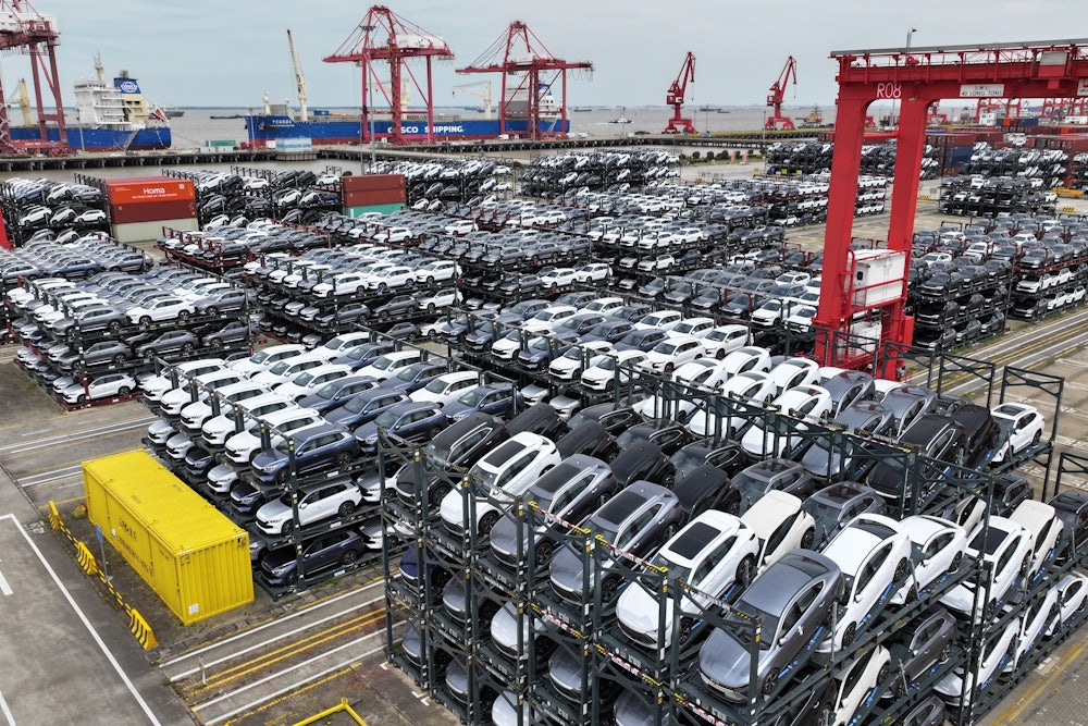 Cars are seen stacked in racks at a container terminal.