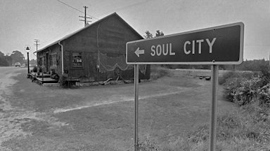 A highway sign for Soul City on Route 1.