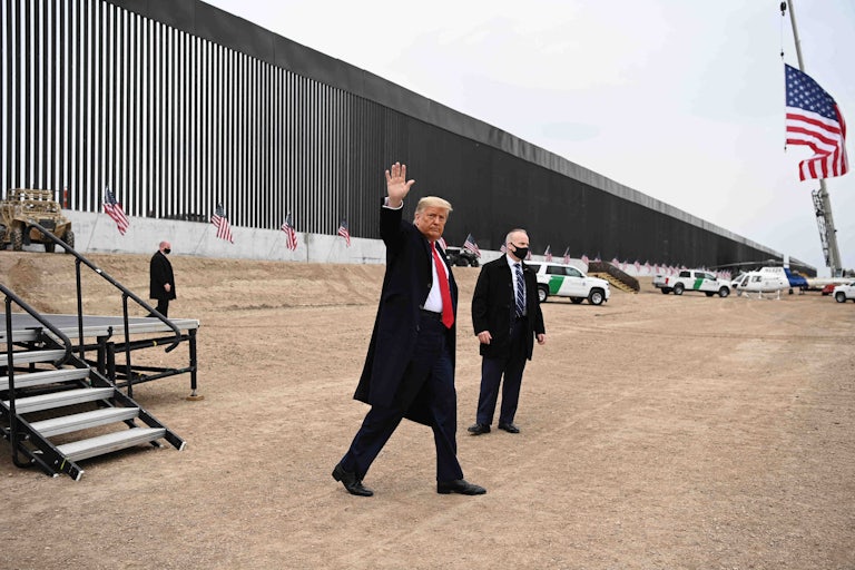 Trump waves in front of the border wall