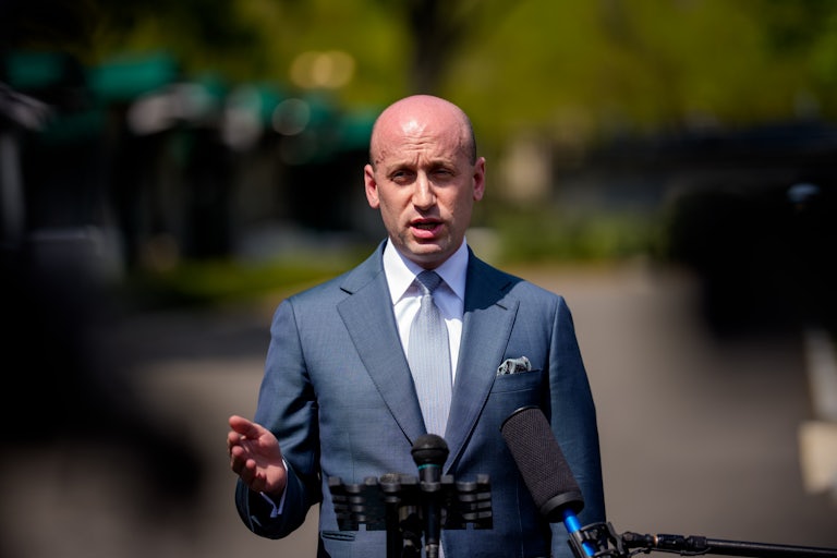 Stephen Miller gestures while speaking to reporters outside the White House