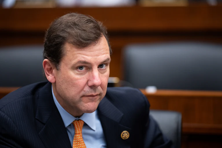 Representative Thomas Kean Jr. looks up while sitting in a House hearing