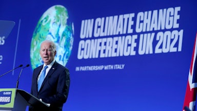 President Joe Biden delivers a speech on stage during a meeting at the COP26 UN Climate Change Conference in Glasgow, Scotland.