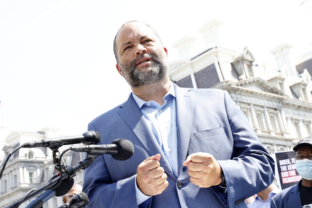 Ben Jealous stands in front of microphones.
