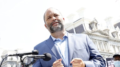 Ben Jealous stands in front of microphones.