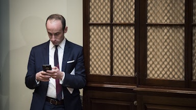 Stephen Miller looks at his phone