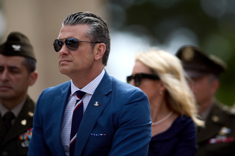 Defense Secretary Pete Hegseth wears sunglasses outside.