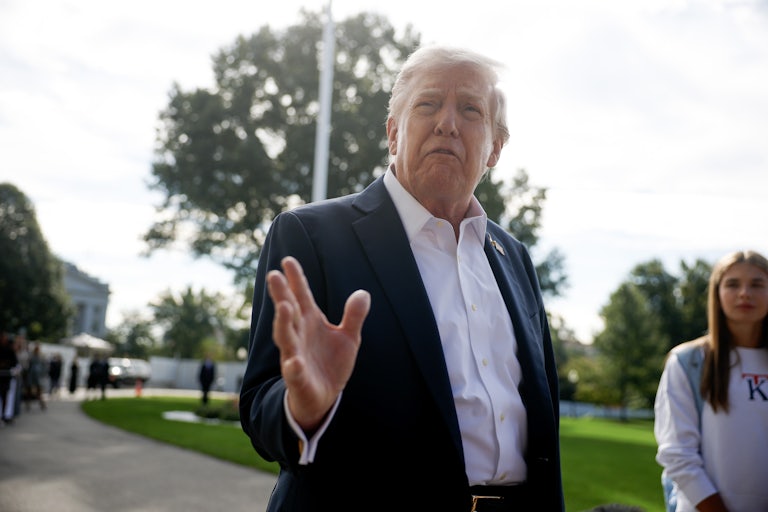 Donald Trump speaks outside the White House as his granddaughter Kai Trump stands in the background.