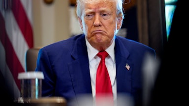 President Trump sits in a meeting in the Oval Office.