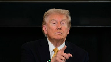 Donald Trump tilts his chin up as he points to a reporter (not pictured).