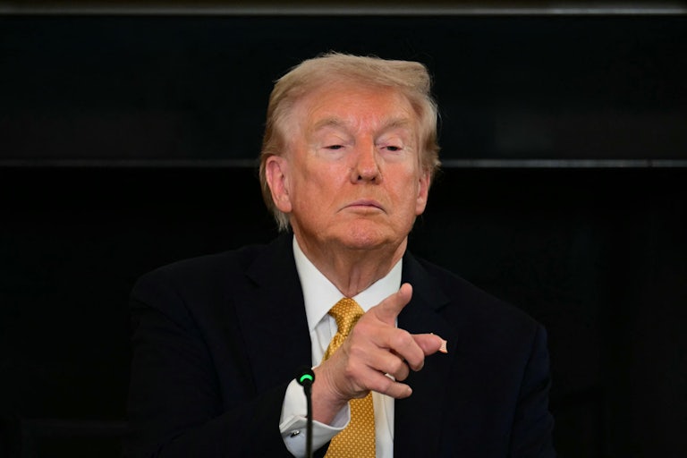 Donald Trump tilts his chin up as he points to a reporter (not pictured).