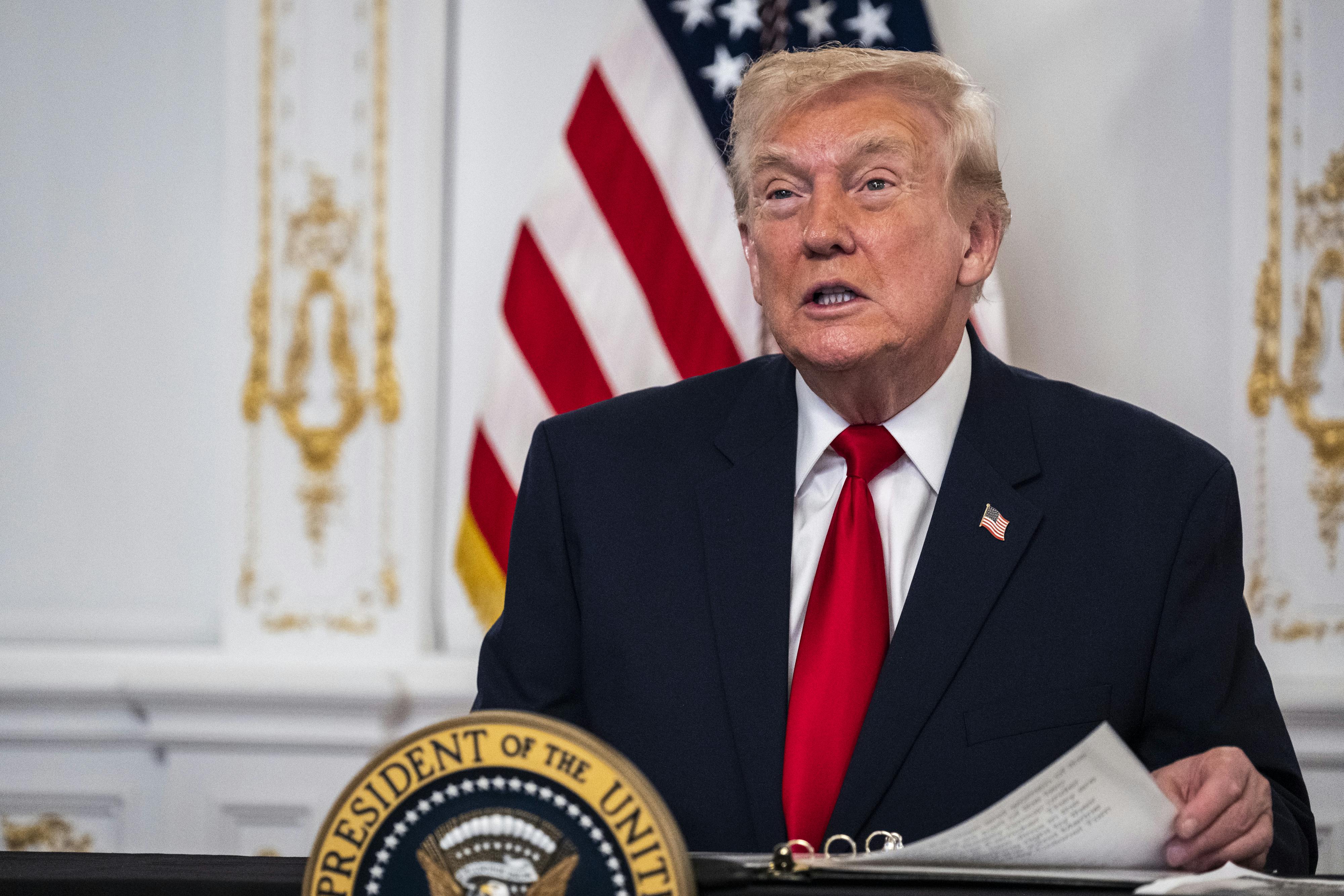 Donald Trump sits at a desk in Mar-a-Lago