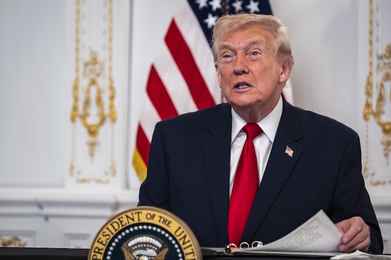 Donald Trump sits at a desk in Mar-a-Lago