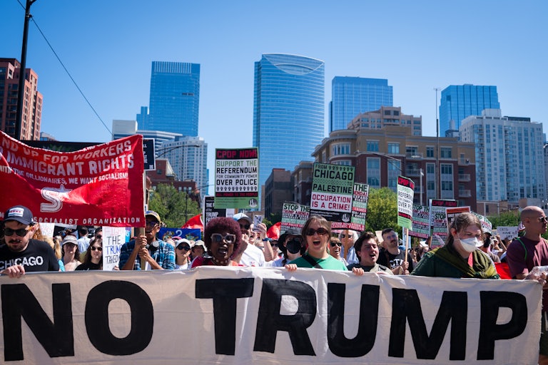 People protest with signs on Labor Day in Chicago, Illinois.